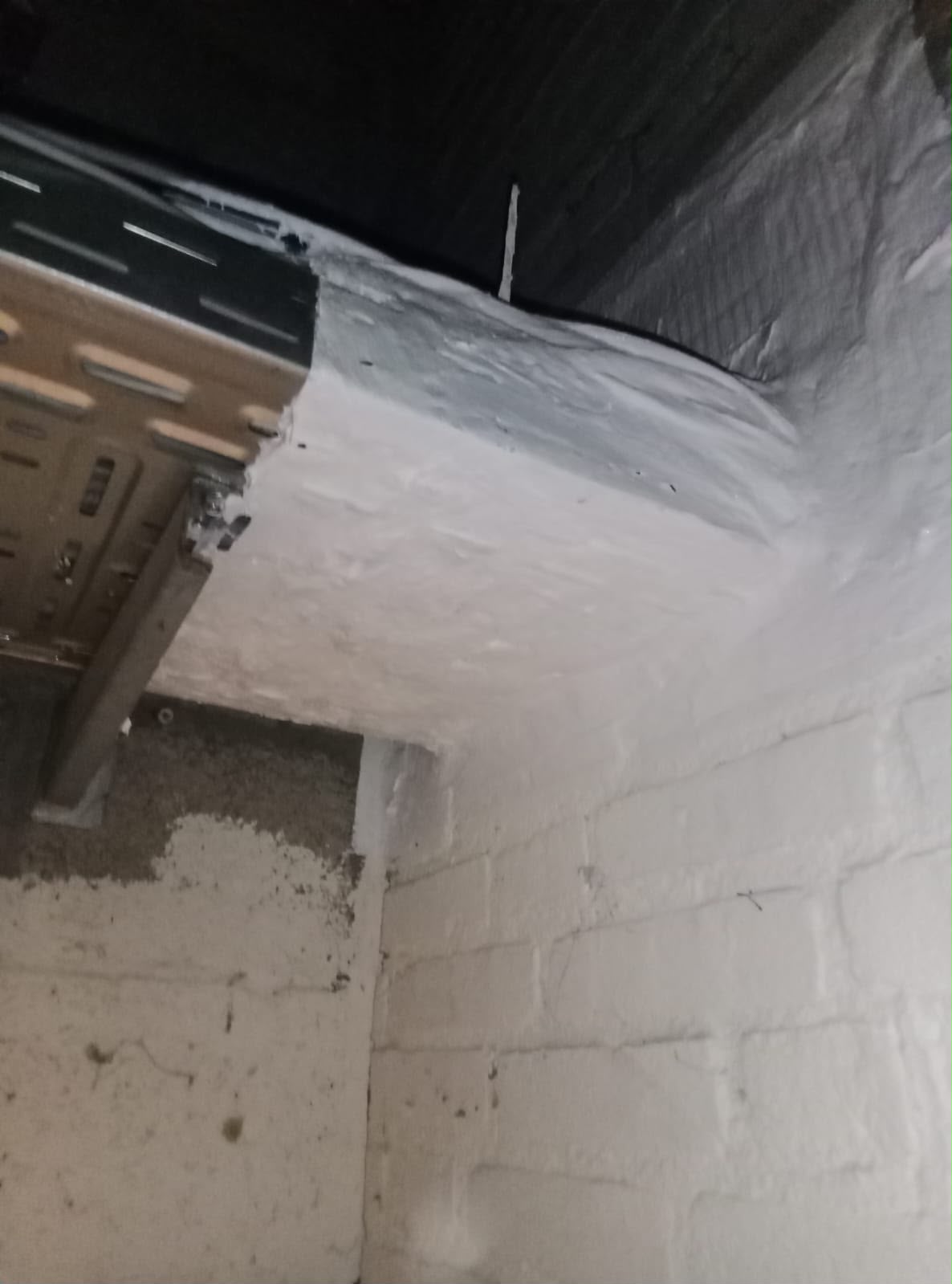Cable tray protected with a firestop coating through a wall