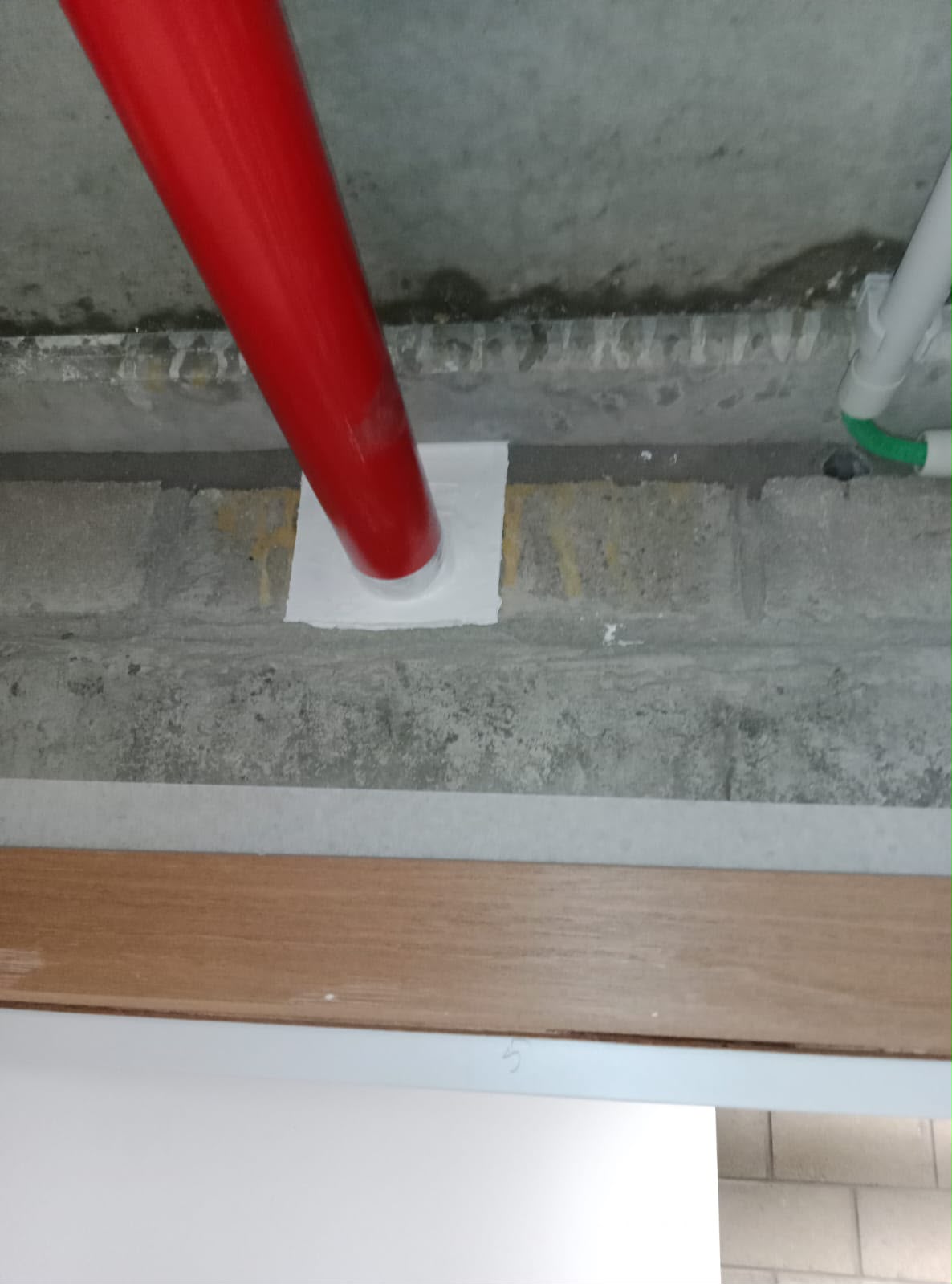 Pipe through a floor sealed with a firestop seal